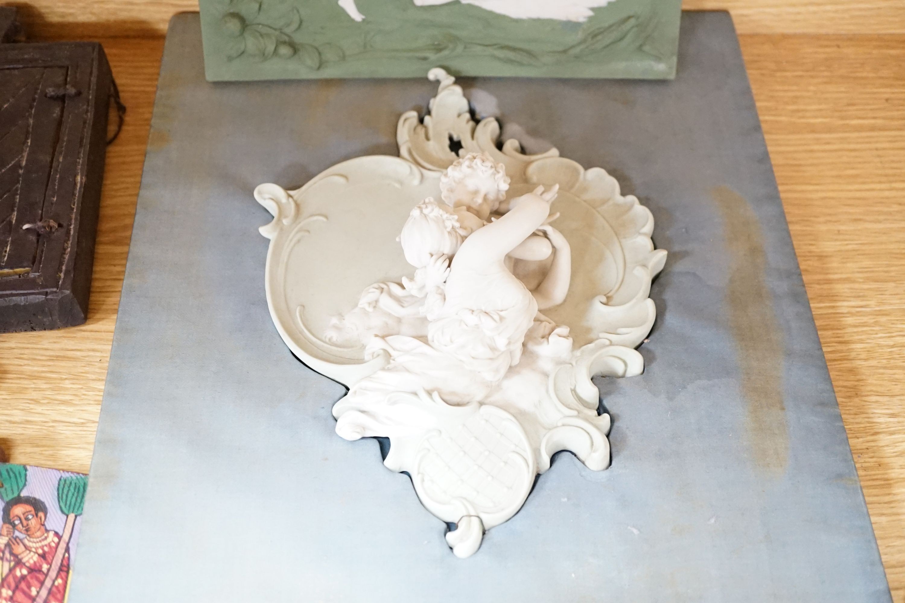 A collection of Limoges-type bisque plaques, largest 25.5 cm